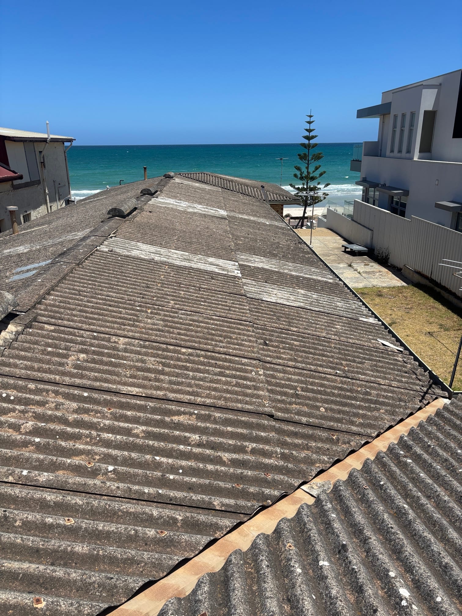 Weathered asbestos-cement roof before replacement at 305 Esplanade, Henley Beach
