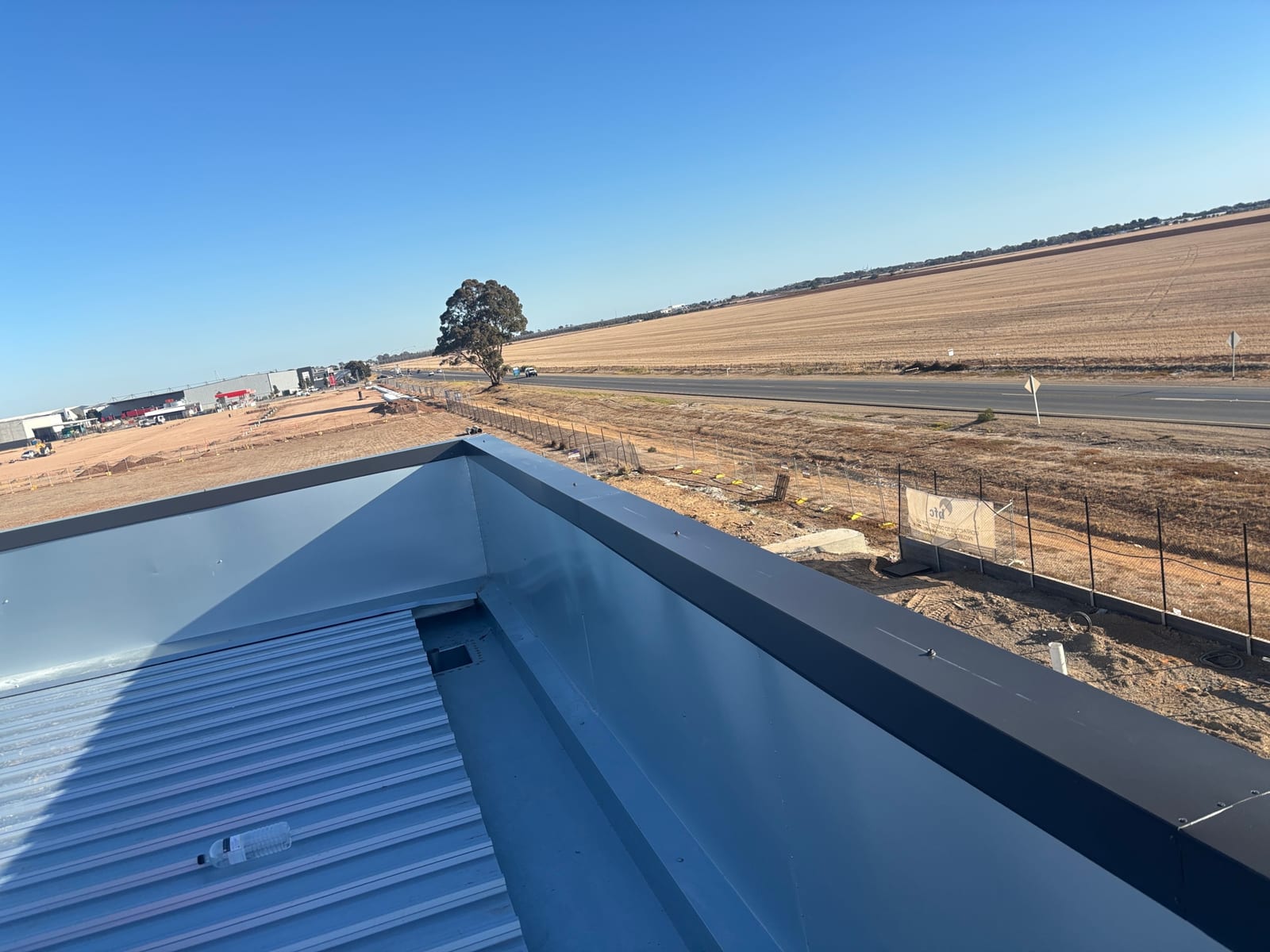 Industrial warehouse re-roof at 74 Mirage Rd Direk, Adelaide rural fringe with fresh Colorbond and parapet capping